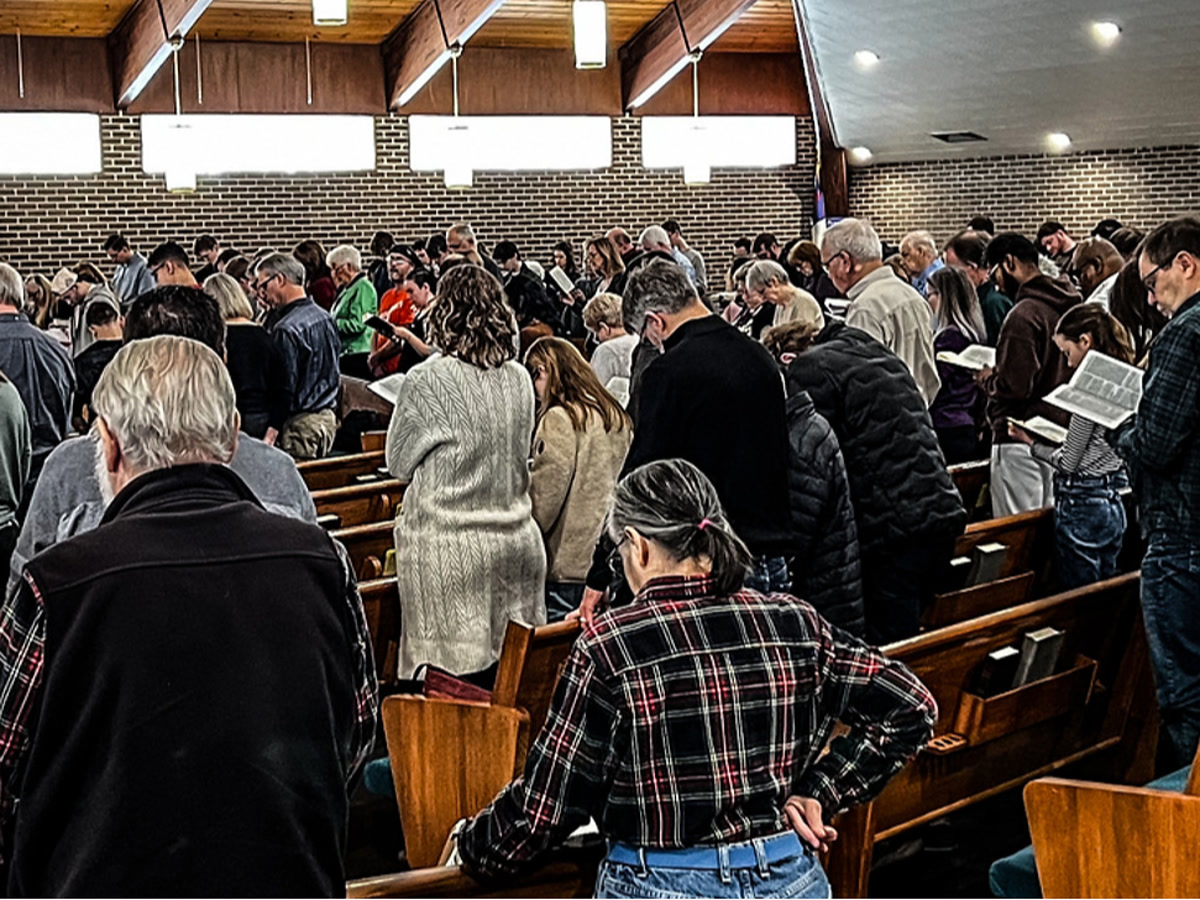 The congregation standing and singing together during worship at Dearborn Christian Fellowship